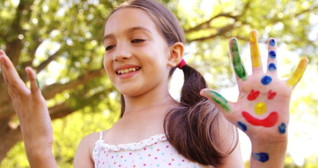 Happy Female Child Enjoying Colorful Finger Painting Outdoors - Download Free Stock Images Pikwizard.com