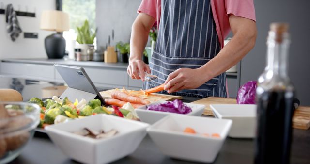 Man Cooking Healthy Meal in Modern Kitchen Using Tablet - Download Free Stock Images Pikwizard.com