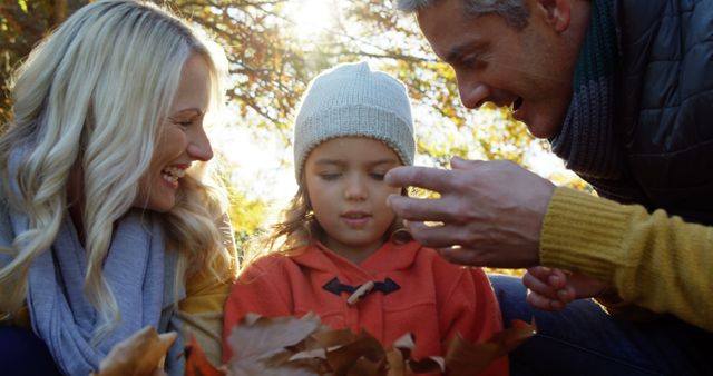 Parents and Child Enjoying Autumn Leaves Outdoors - Download Free Stock Images Pikwizard.com