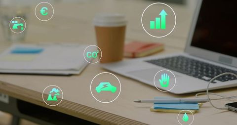 Desk with laptop, coffee cup and floating green icons conveying sustainable office growth