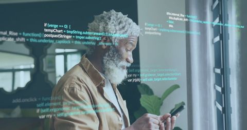 Elderly businessman engaging with mobile technology hologram