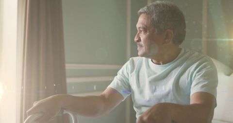 Pensive Senior Man in Sunny Room Contemplating Life