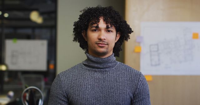 Portrait of happy biracial businessman looking at camera at office. Work at a modern office.