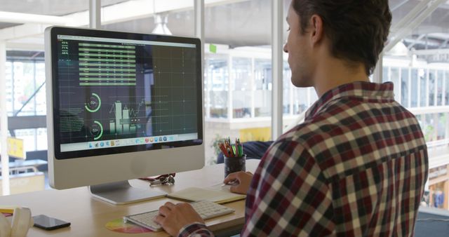 Man Analyzing Data on Desktop Computer in Modern Office - Download Free Stock Images Pikwizard.com