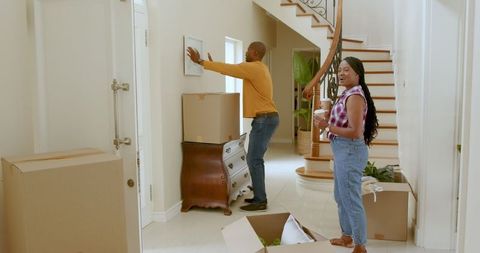 Couple arranging their new home enthusiastically