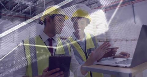 Engineers Collaborating with Technology on Construction Site