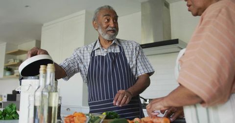 Senior Couple Enjoying Cooking Together in Home Kitchen Setting