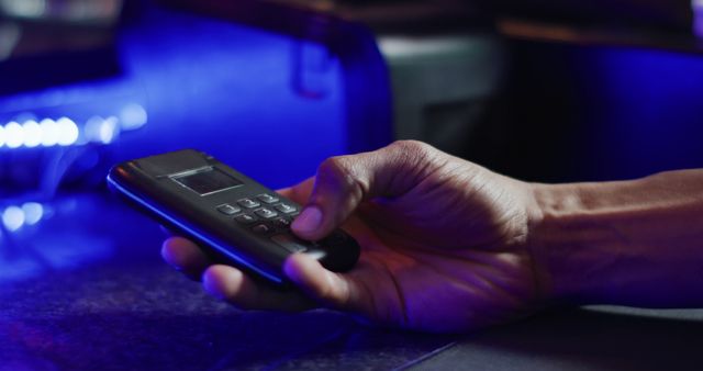 Close-Up of Hand Using a Secure Payment Device in Low Light - Download Free Stock Images Pikwizard.com