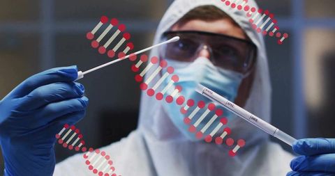 Laboratory technician holding swab and specimen tube in full ppe with dna helix overlay