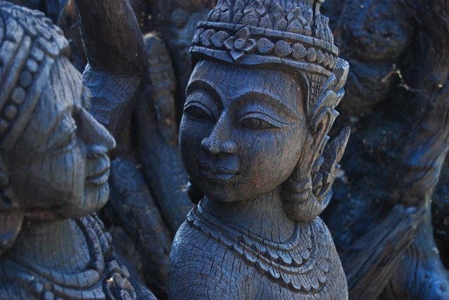Close-Up of Ornate Wooden Sculptures of Ancient Deities - Download Free Stock Photos Pikwizard.com
