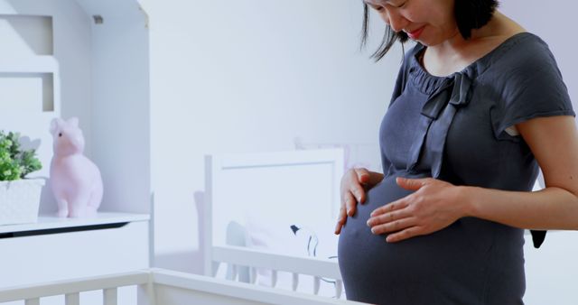 Pregnant Woman Smiling in Nursery with Baby Crib - Download Free Stock Images Pikwizard.com