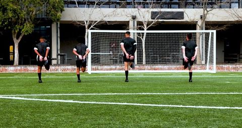 Soccer Players Warming Up on Field for Outdoor Practice