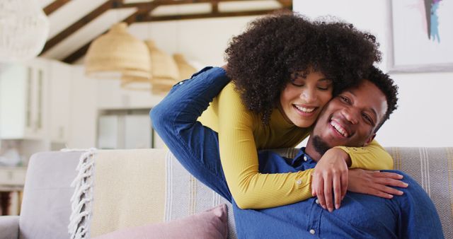 Happy african american couple embracing in living room. Spending quality time at home together concept.