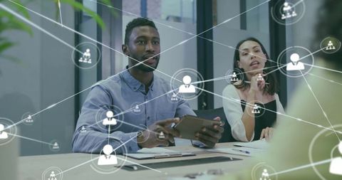 Business professionals engaged with digital network overlay