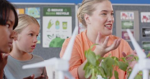 Teacher explaining wind turbines in innovative stem workshop