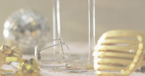Leftover celebration details with silver muselet, champagne flutes and gold confetti