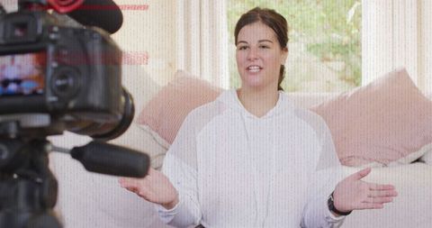 Caucasian woman vlogger recording content with camera
