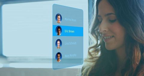 Woman selecting holographic contact list while opening animated profile card interface