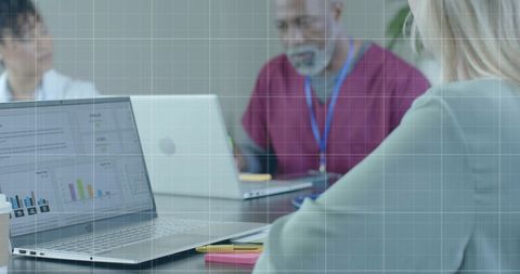Diverse Medical Team Analyzing Financial Data on Laptops