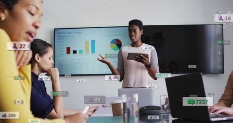 Business leader presenting data with tablet in modern conference room during team meeting