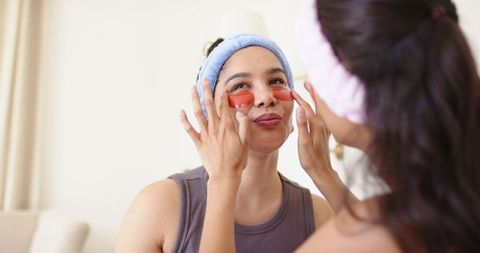 Friends applying under-eye gel patches during at-home skincare routine