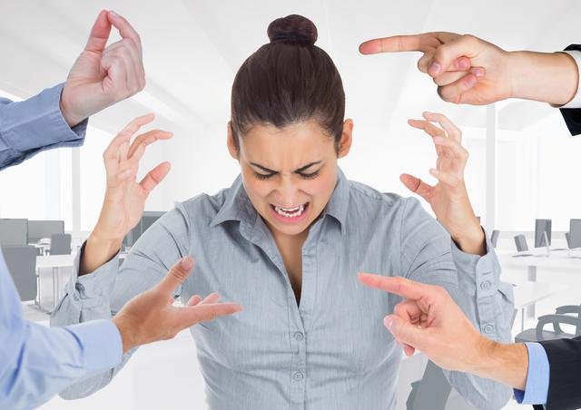 Hands blaming a stressed woman in office