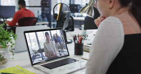 Professional Woman Engaging in Video Conference at Modern Office