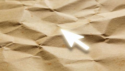 Glowing cursor arrow hovering over crumpled kraft paper texture