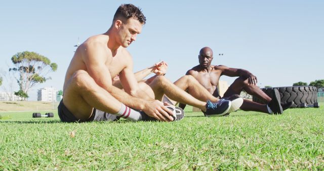 Diverse group of three fit men cross training outside. cross training for fitness at a sports field.