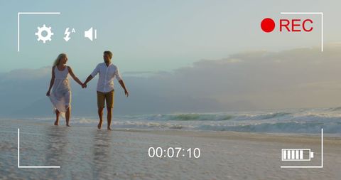 Romantic Couple Strolling on Beach Captured as Video Footage