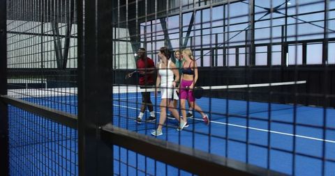 Diverse Friends Walking on Padel Court Holding Rackets