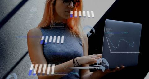 Young woman typing on laptop with holographic data overlays, charts and code interface