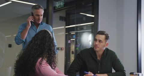 Three Colleagues Engaging in Professional Meeting Environment