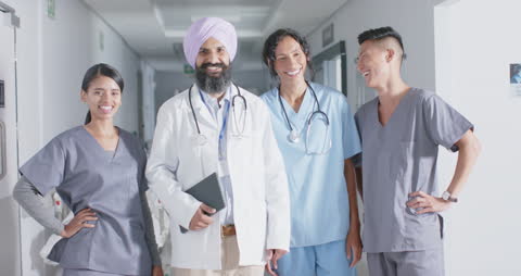 Diverse Medical Team Smiling Together in Hospital Corridor