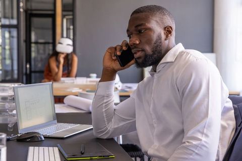 Architectural Team Collaborating with Digital Tools in Modern Studio