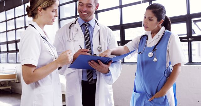 Healthcare Team Discussing Patient Records in Hospital Setting - Download Free Stock Images Pikwizard.com