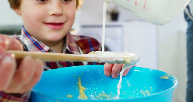 Smiling Child Mixing Batter in Kitchen - Download Free Stock Images Pikwizard.com