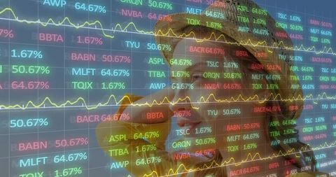 Analyst on trading floor focused on stock tickers