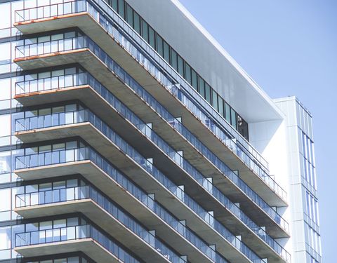 Modern high-rise condo building with glass balconies