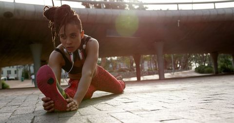 Focused African American Woman Stretching Outdoors