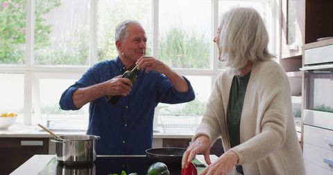 Senior Couple Cooking Together in a Bright Kitchen