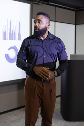 African American Professional Presenting Data in Corporate Meeting