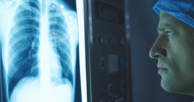 Doctor Examining Chest X-ray in Dimly Lit Medical Facility - Download Free Stock Images Pikwizard.com