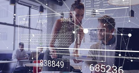 Coworkers Analyzing Digital Data in Modern Office Workspace