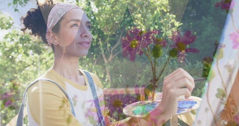 Sunlit garden artist painting floral canvas with palette and brush outdoors