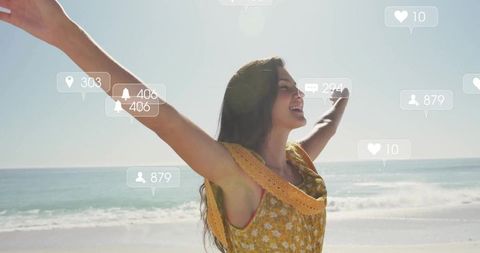 Joyful Young Woman Embracing Beach Breeze with Social Media Connections