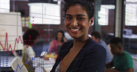 Confident Businesswoman Analyzing Financial Data and Graphs