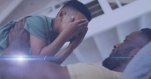 Loving Father Playing with Son Indoors