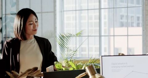 Professional Woman Analyzing Corporate Strategy in Modern Office