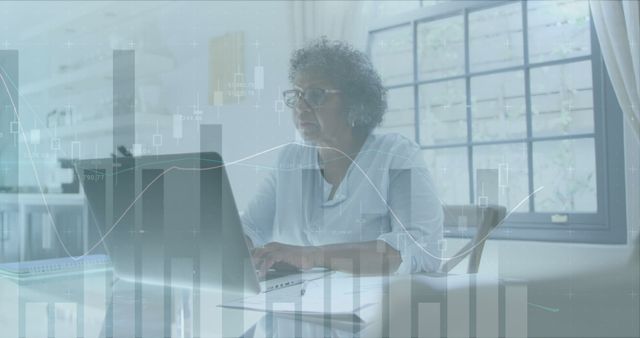 Senior Woman Analyzing Financial Data on Laptop with Graphical Overlay - Download Free Stock Images Pikwizard.com